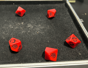 Five WtA symbol dice with three blanks and two rage symbols.